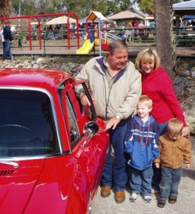 Dale and Pam Perry pose beside their 1969 Nova with Josh and Matthew (Chancey) at the 2013 Fiddler Crab Festival.